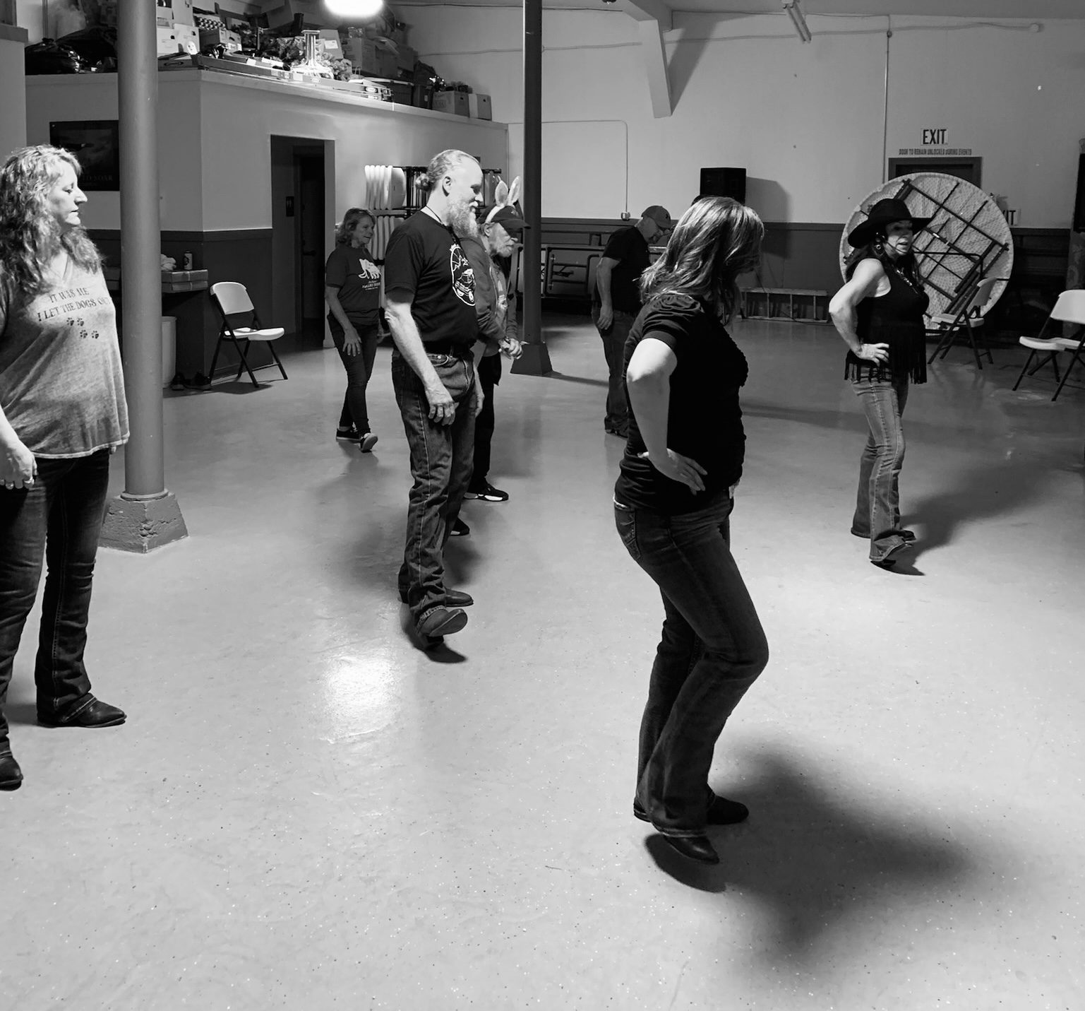 Dancers working through a step together in a hall